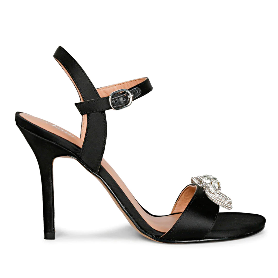 Black leather-satin stilettos by Saint Hayden, adorned with a crystal bow for a chic and stylish vibe