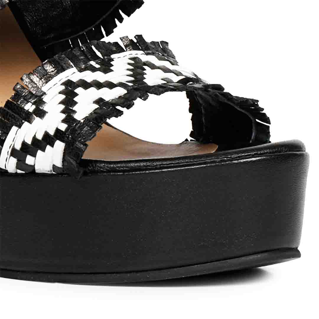 Explore luxury in Saint Kimberly's handwoven wedge heels.