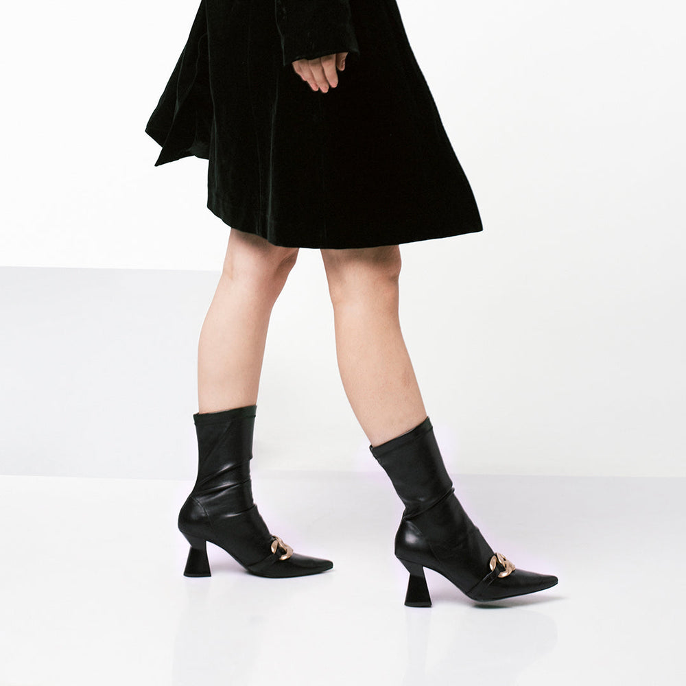Sleek black pointed heel boots, Saint Rosalie, crafted with stretch Napa for a chic look. Elevate your style with these sophisticated calf boots