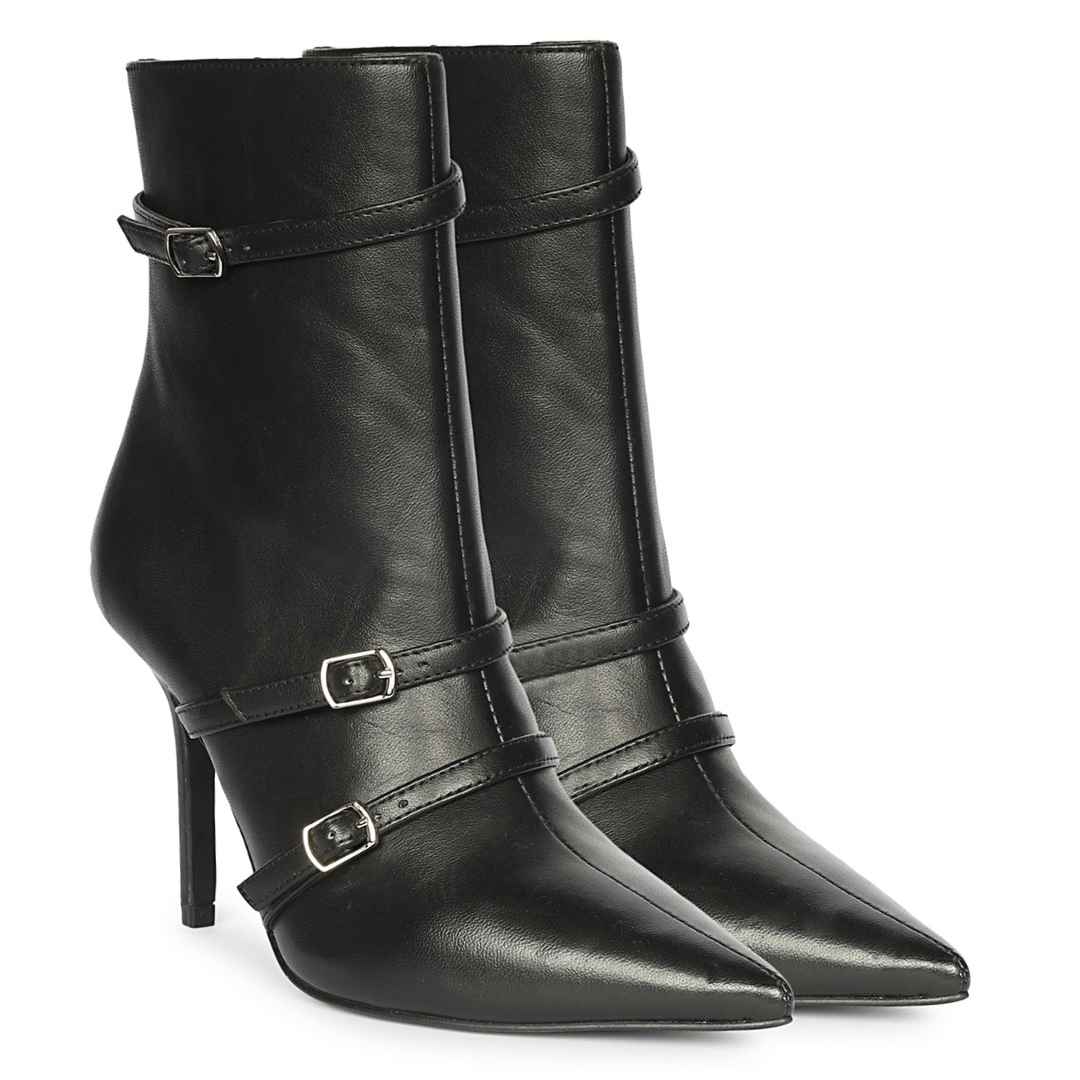 A pair of black leather ankle boots with pointed toes, high stiletto heels, and decorative silver buckle straps