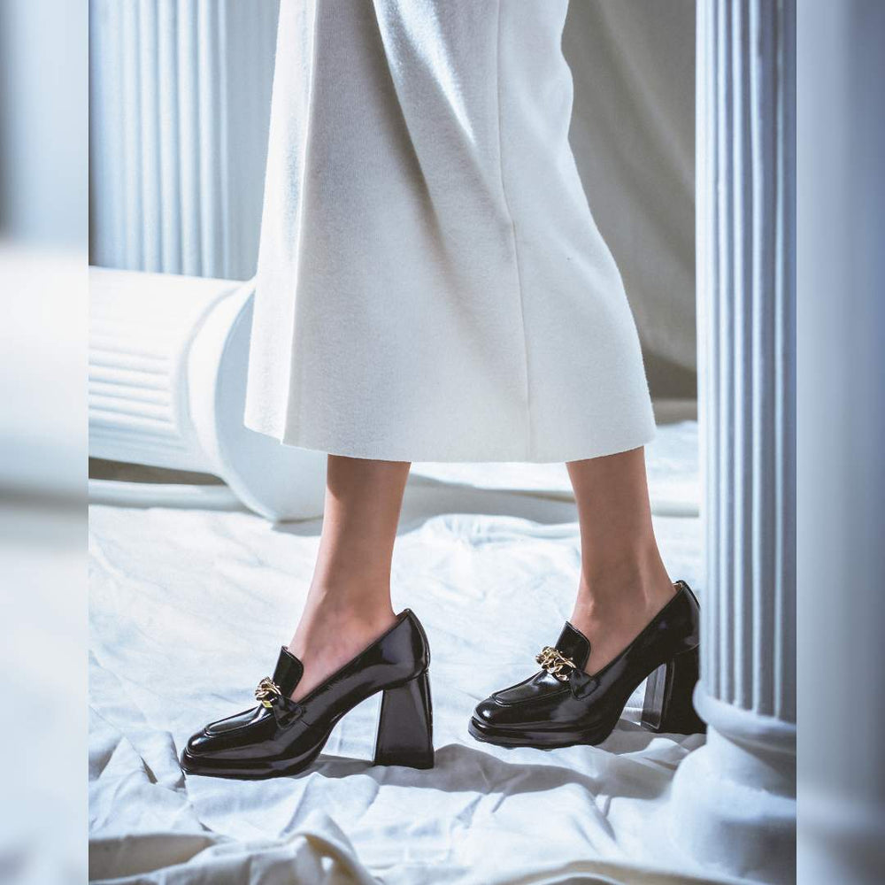 Step out in style: Saint Benoîte's black patent leather moccasins, expertly handcrafted for a touch of luxury.