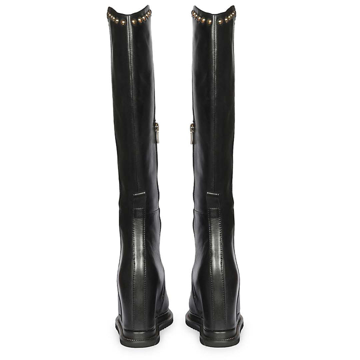 A pair of black leather knee-high boots shown from the back, featuring gold-tone metal studs along the top collar and a side zipper