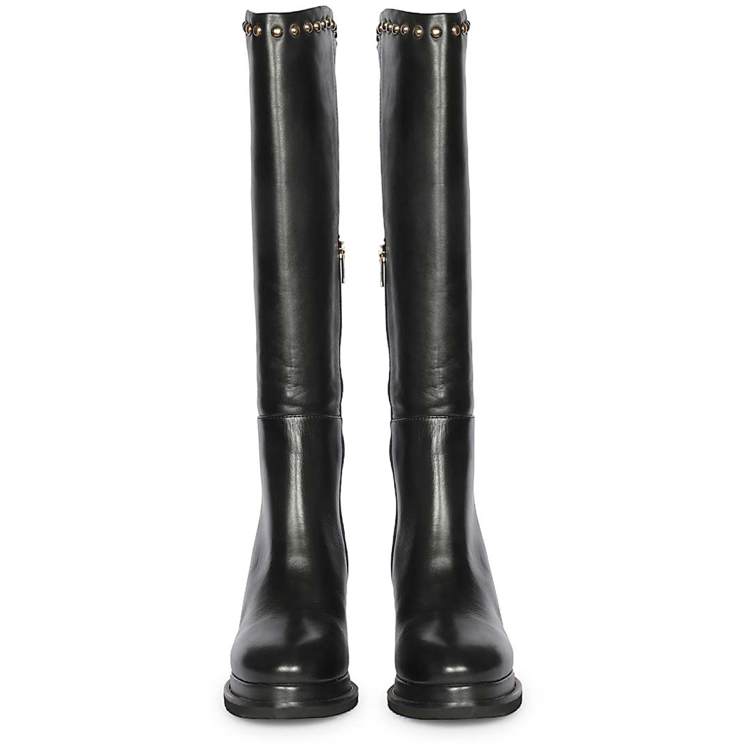 A pair of black leather knee-high boots with gold-tone rivet detailing around the top collar
