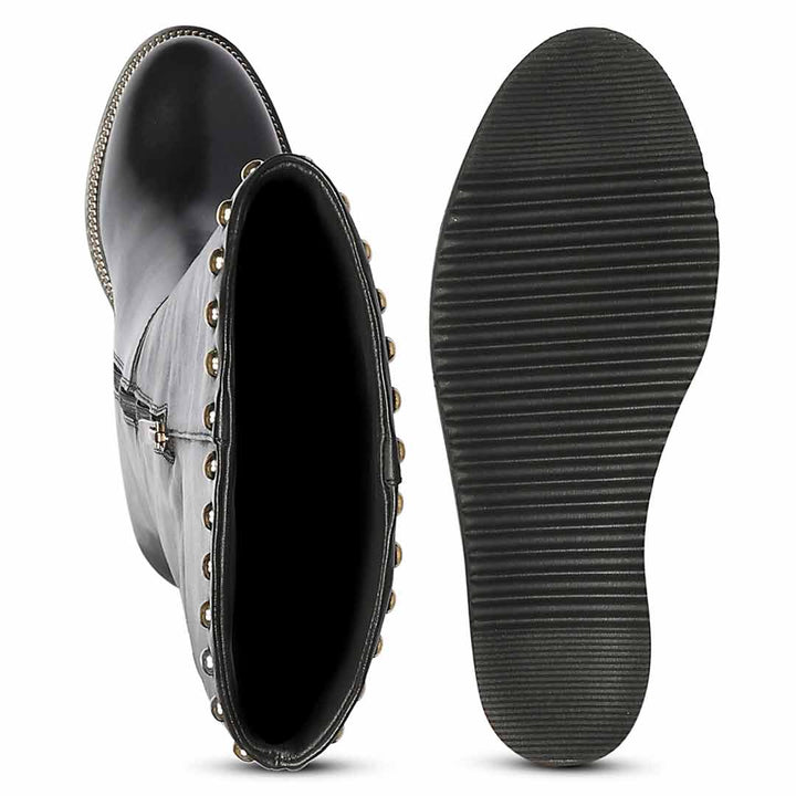 A pair of black mid-calf boots shown on a white background, with one boot displaying the side and open top decorated with metallic studs