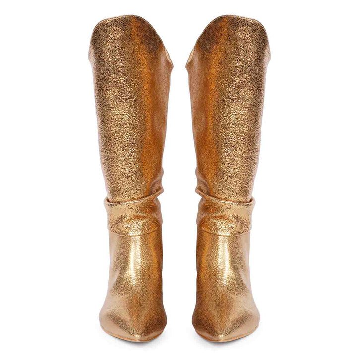 Versatile and glamorous, Saint Nayeli's gold metallic slouch boots for any outfit.