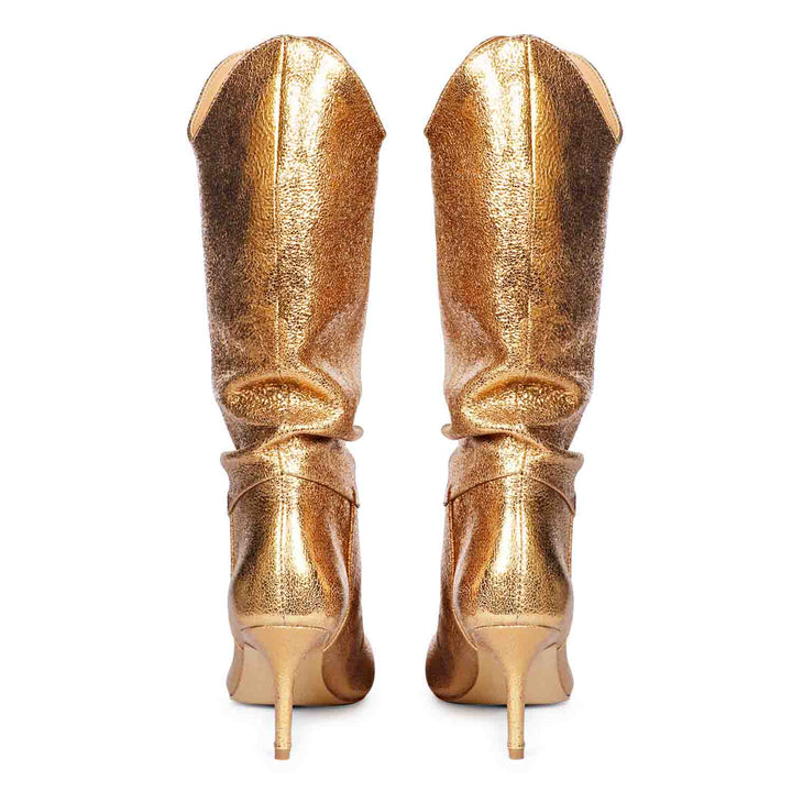 Versatile and glamorous, Saint Nayeli's gold metallic slouch boots for any outfit.