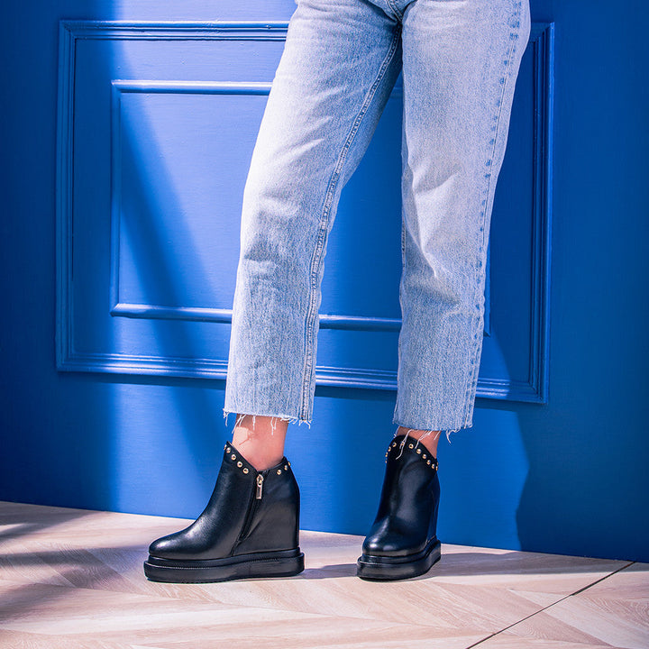 Saint Emily Black Suede Wedge Boots: Elevate your style with these chic ankle boots featuring a comfortable inner wedge heel in luxurious black suede leather.