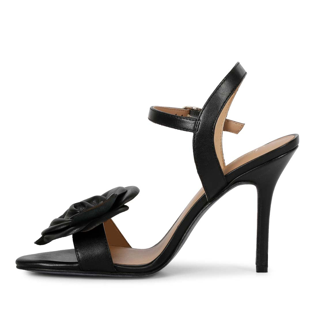 Black leather stilettos by Saint Veronique, featuring stunning floral details for a fashionable and classy look