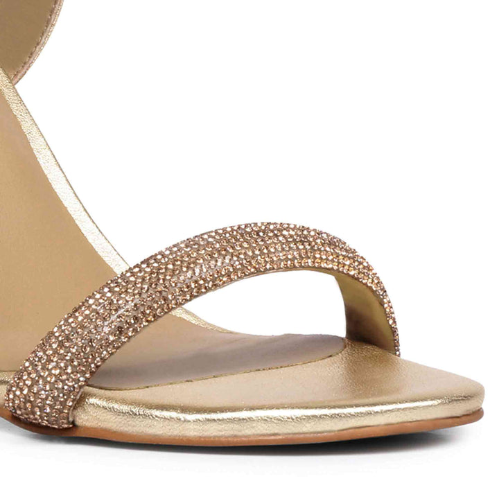 Metallic gold leather block heels by Saint Gracie featuring sparkling strass embellishments.