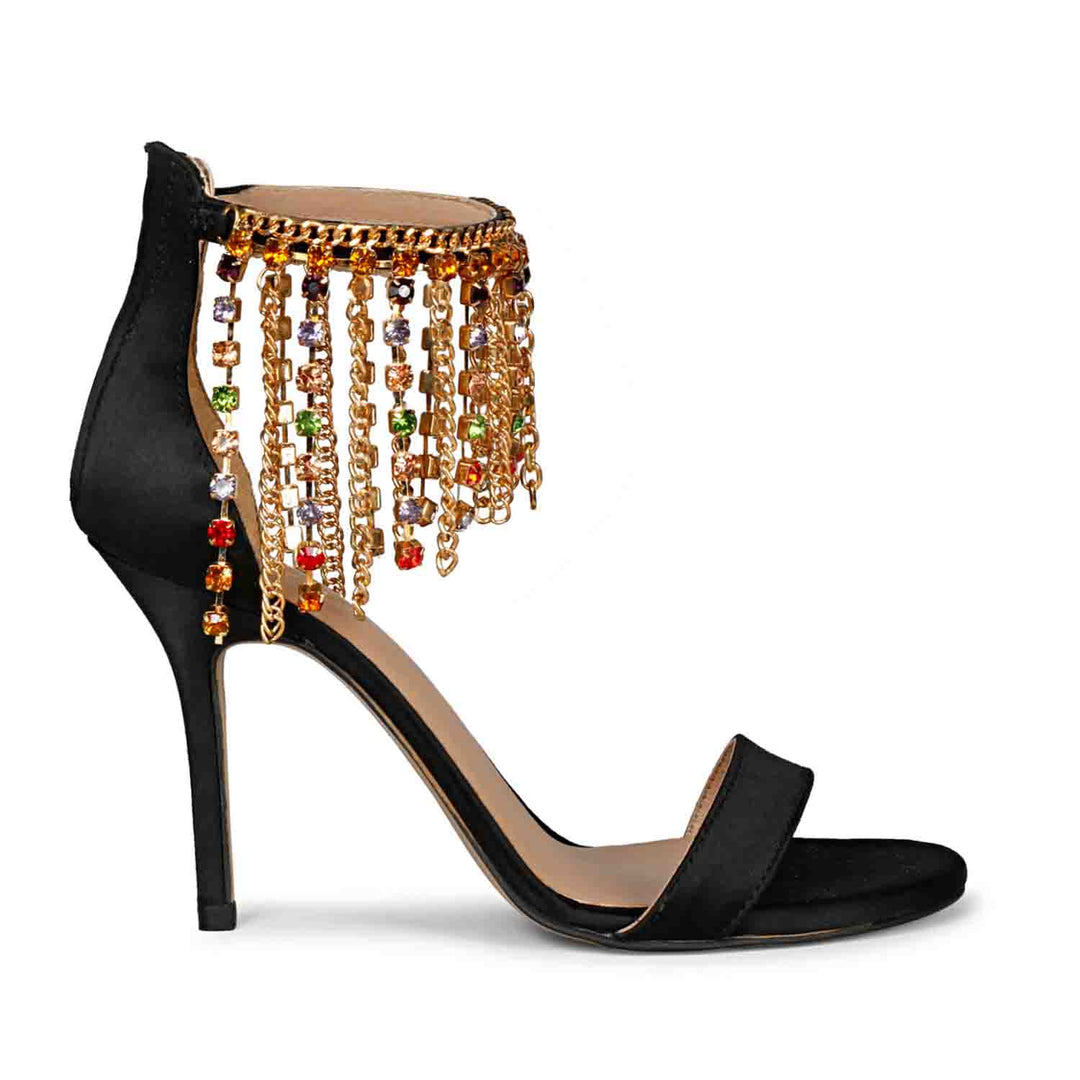 Saint Luana's black satin stilettos, adorned with multi-stone studs and a stylish chain, add a touch of luxury to your ensemble. Walk in glamour